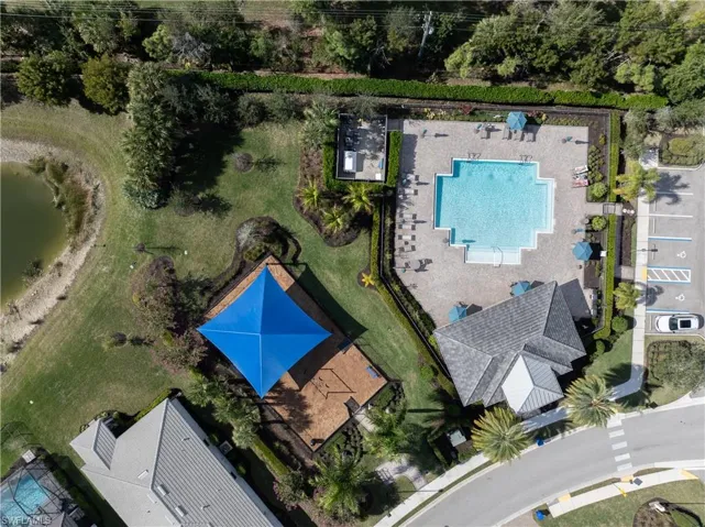 Aerial view of property and surrounding area featuring a pool area