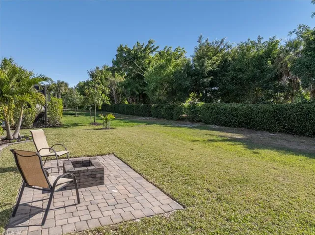 Fenced backyard featuring a patio and an outdoor fire pit
