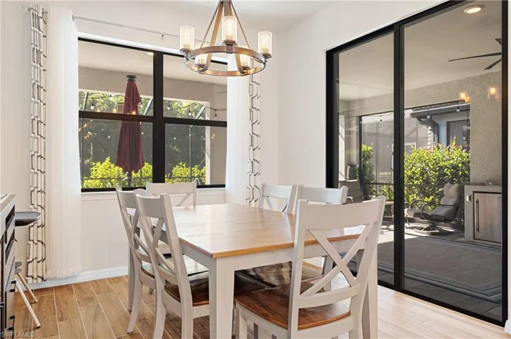 Dining area with wood tiled floors and a chandelier