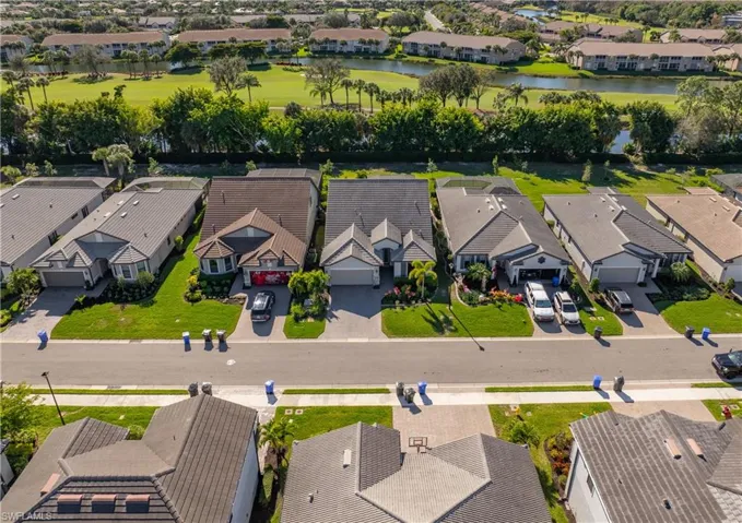 Aerial perspective of suburban area featuring a large body of water