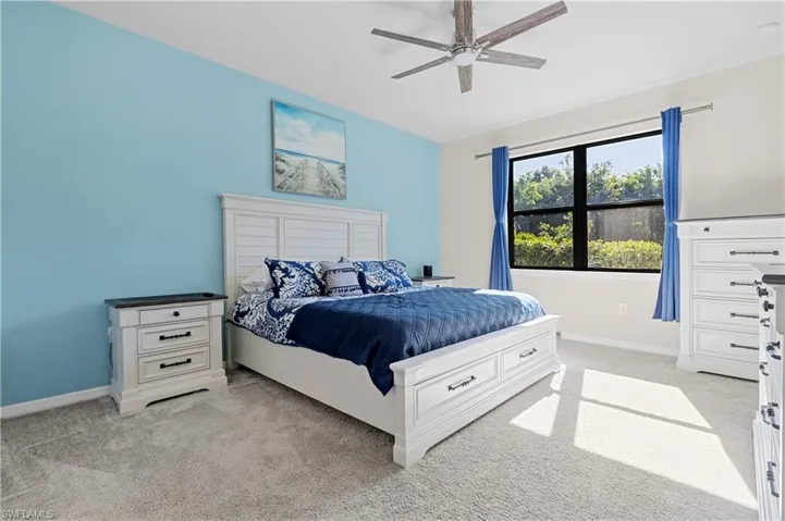 Bedroom featuring light carpet and a ceiling fan