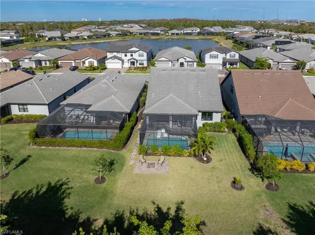 Aerial perspective of suburban area featuring a pool