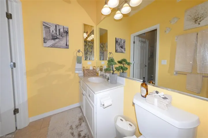 Guest Bathroom with full tub and shower, Tiled floor and upgraded lighting.
