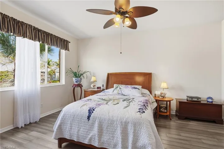 Bedroom with light wood-type flooring and a ceiling fan