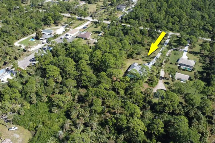 Aerial view of property's location featuring a forest