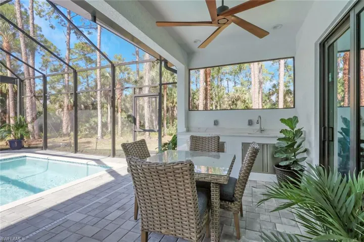 Sunroom with a patio area, a ceiling fan, and outdoor dining area