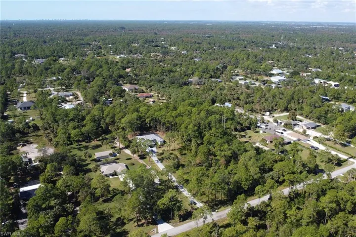 Aerial view of property's location with a forest