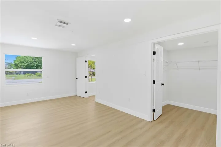 Well-appointed primary bedroom highlighted by a large walk-in closet, providing abundant storage and everyday convenience.
