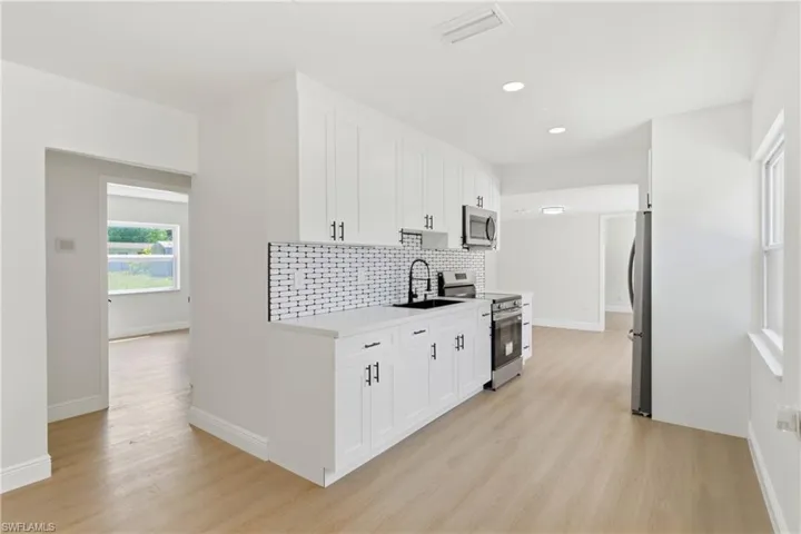 Warm and welcoming kitchen designed for comfort and efficiency, featuring ample storage and a functional flow.