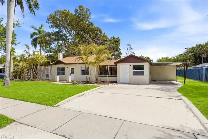 Spacious driveway and 1-car carport with ample parking.