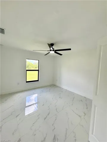 Bathroom featuring a marble finish shower, vanity, a textured ceiling, and light marble finish flooring