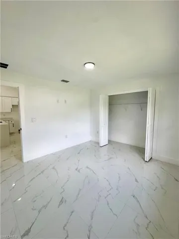 Empty room featuring light marble finish floors, recessed lighting, and a ceiling fan