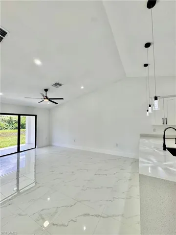 Unfurnished bedroom with light marble finish flooring and a closet