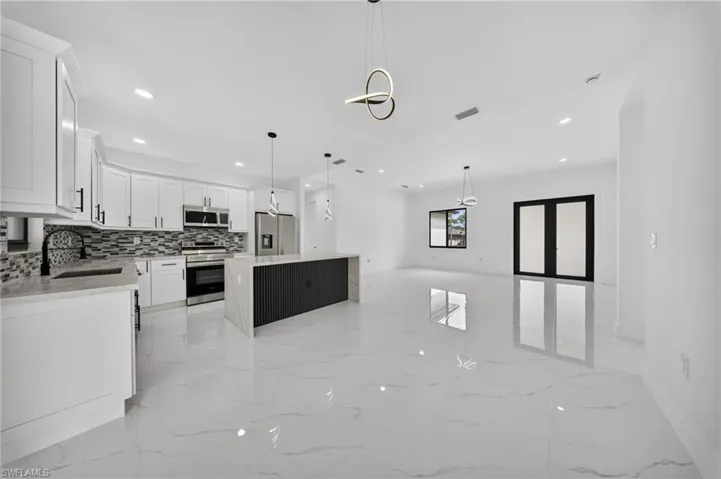 Open-concept living space with large format tile flooring throughout
