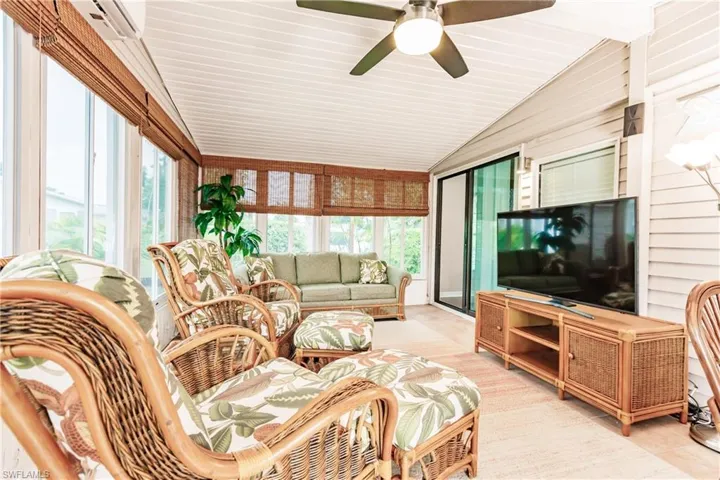 Sunroom with ceiling fan and lofted ceiling