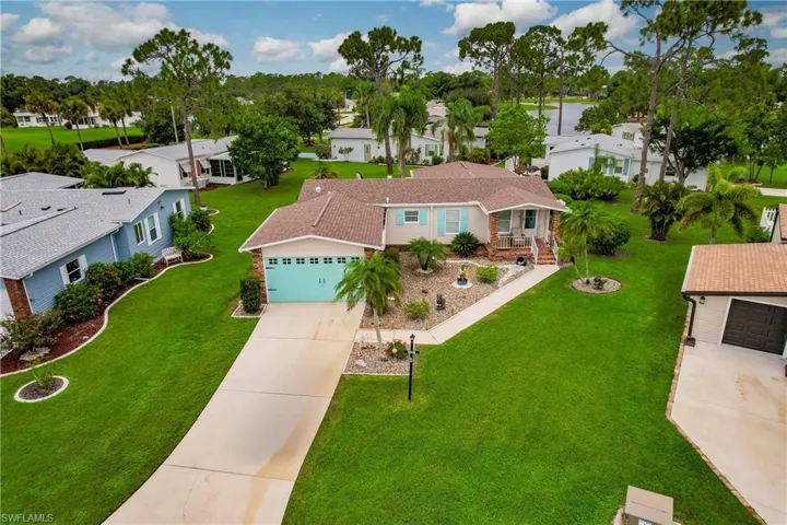 View of front of property with a garage and a front yard