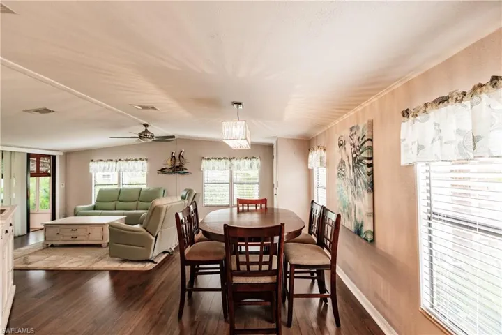 Dining room featuring dark wood-type flooring and ceiling fan