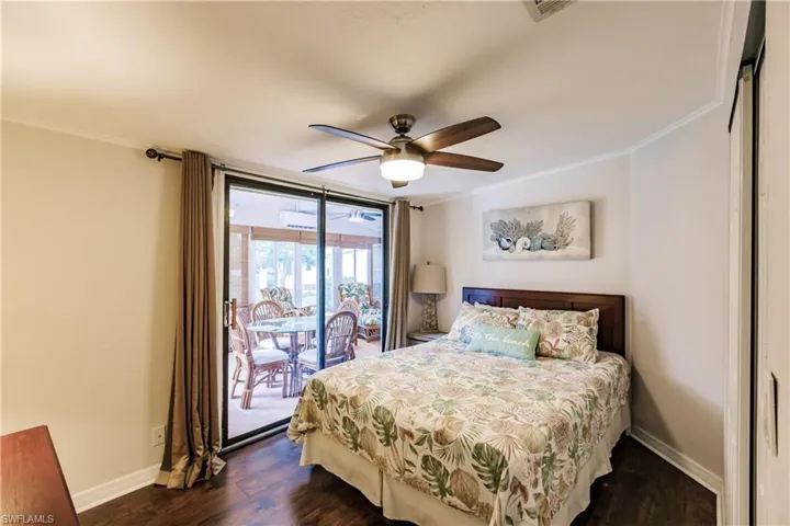 Bedroom featuring access to exterior, crown molding, dark hardwood / wood-style floors, and ceiling fan