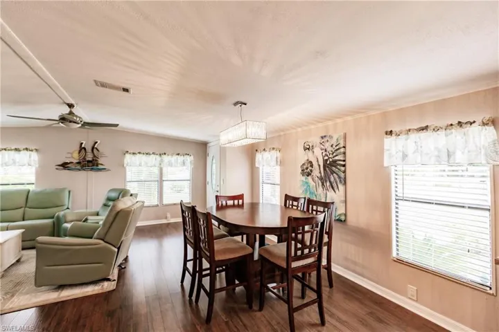 Dining area featuring ceiling fan and dark wood-type flooring
