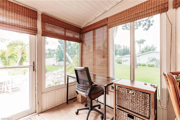 Office space with light tile patterned flooring, vaulted ceiling, and a wealth of natural light