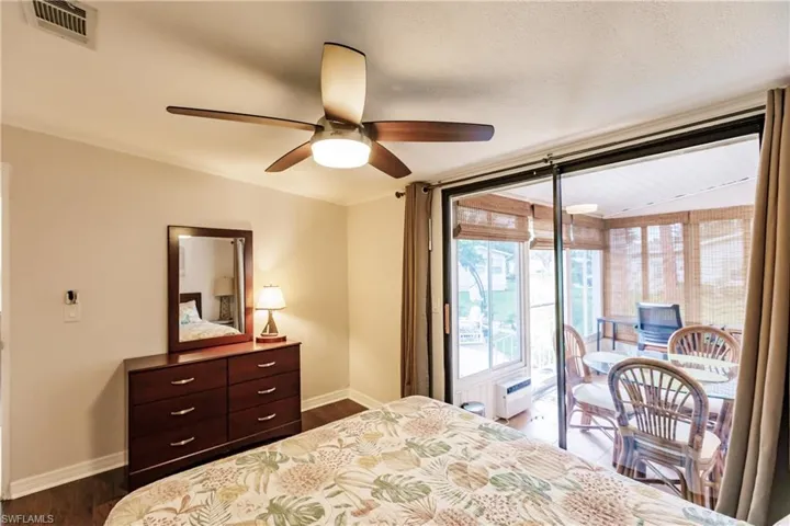 Bedroom with access to exterior, ceiling fan, and hardwood / wood-style flooring