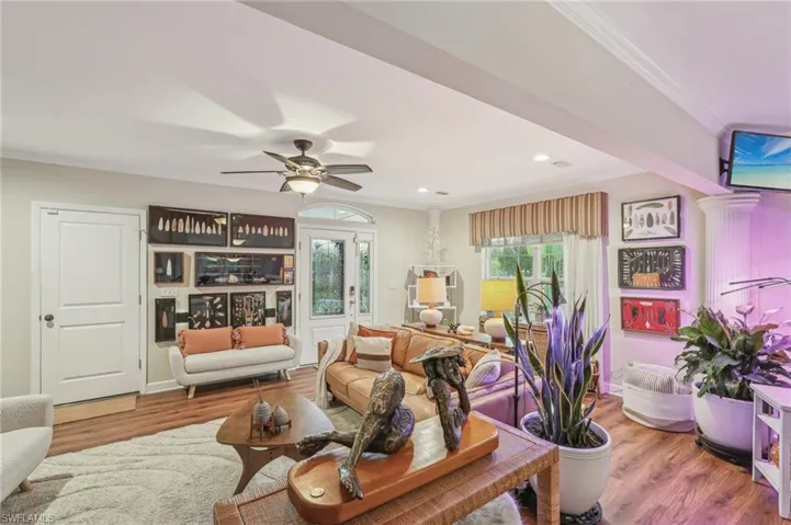 Living area featuring recessed lighting, ornamental molding, a ceiling fan, and wood finished floors