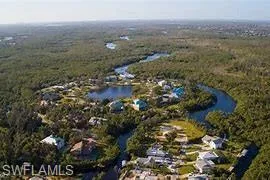 Drone / aerial view with a view of trees and a water view