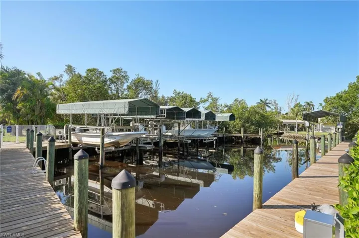 View of dock with a water view and boat lift
