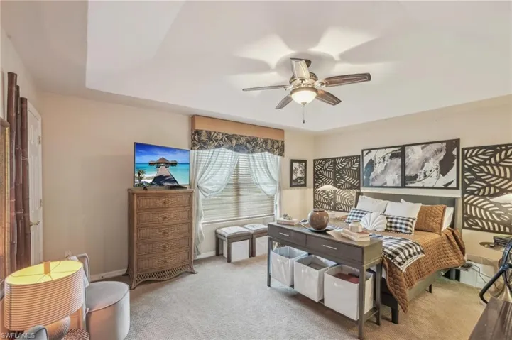 Bedroom featuring carpet flooring, baseboards, and a ceiling fan