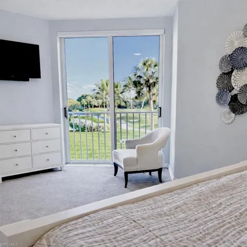 Bedroom with access to exterior and carpet floors