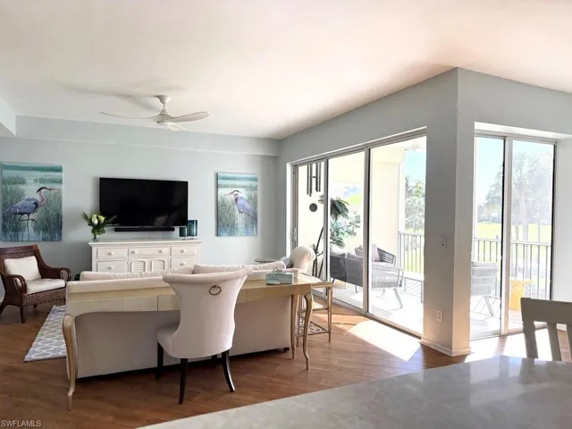 Living room with hardwood / wood-style floors and a ceiling fan