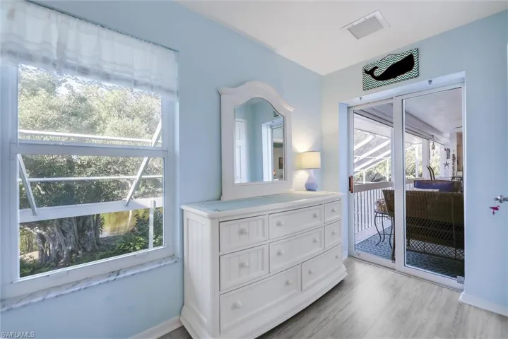 Bedroom with access to outside and light wood-style floors