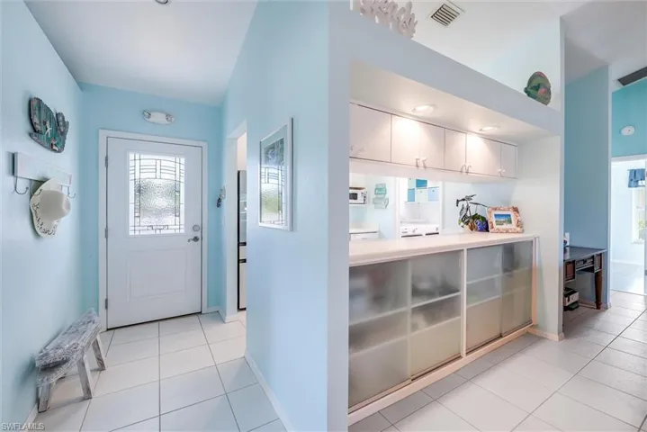 Foyer featuring light tile patterned floors