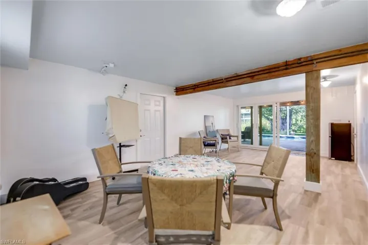 Dining room featuring wood finished floors and beam ceiling