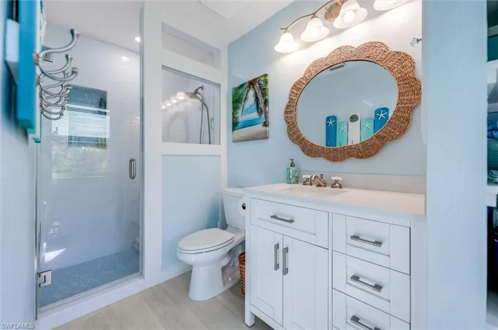 Full bath with vanity and a shower stall