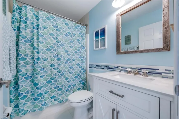 Bathroom featuring vanity and curtained shower