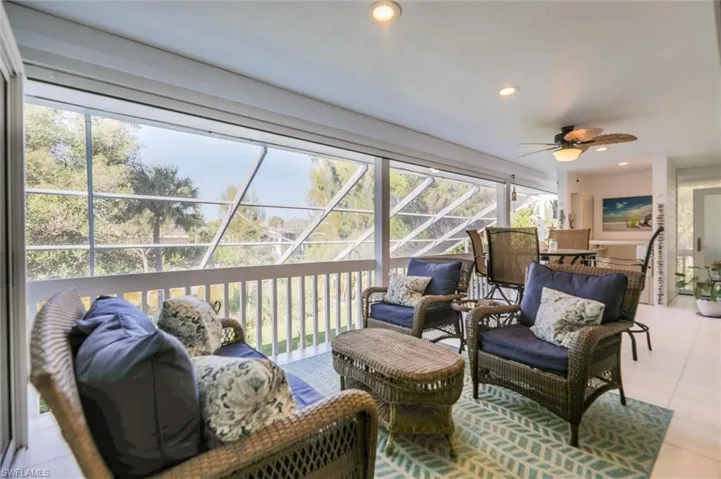 Sunroom featuring an outdoor living space and a ceiling fan