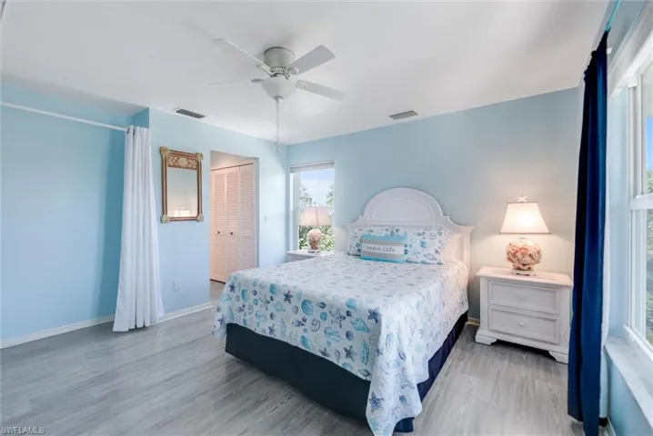 Bedroom featuring a ceiling fan, a closet, and light wood finished floors