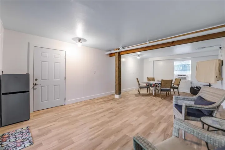 Living room with light wood-type flooring and baseboards