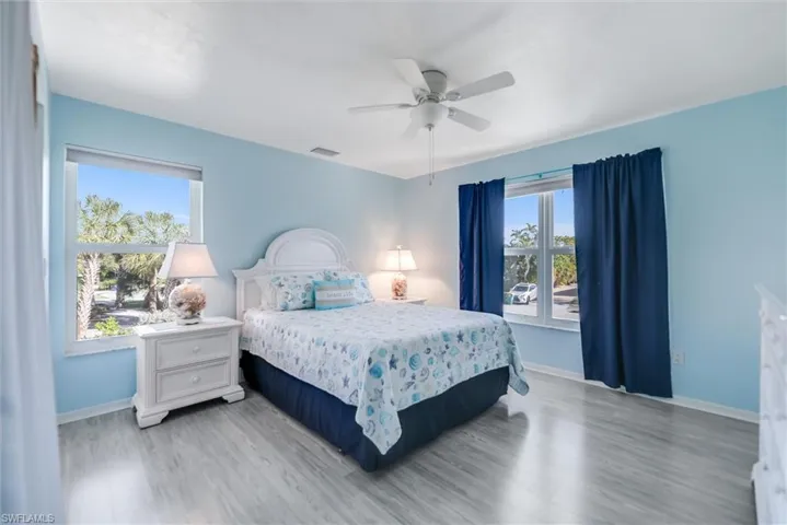 Bedroom with ceiling fan and wood finished floors