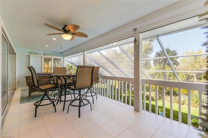 Sunroom / solarium with tile patterned flooring and recessed lighting