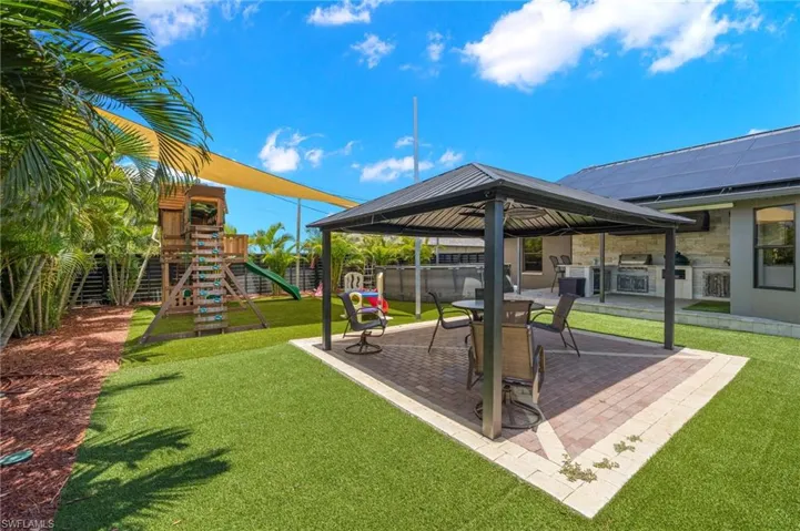 View of yard featuring a playground and a gazebo