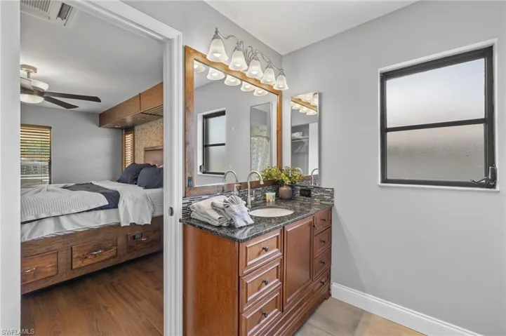 Bathroom featuring ceiling fan, hardwood / wood-style flooring, and vanity