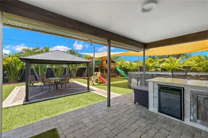 View of patio / terrace featuring a playground and a gazebo