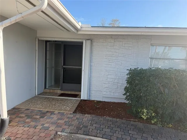 Entrance to property with stone siding