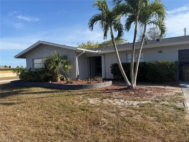 View of front of home with a front yard and brick siding
