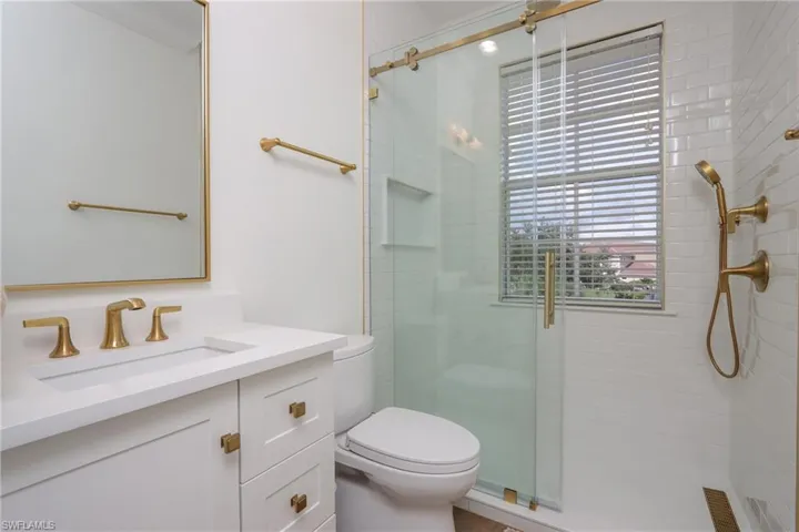 Full bathroom featuring a shower stall and vanity