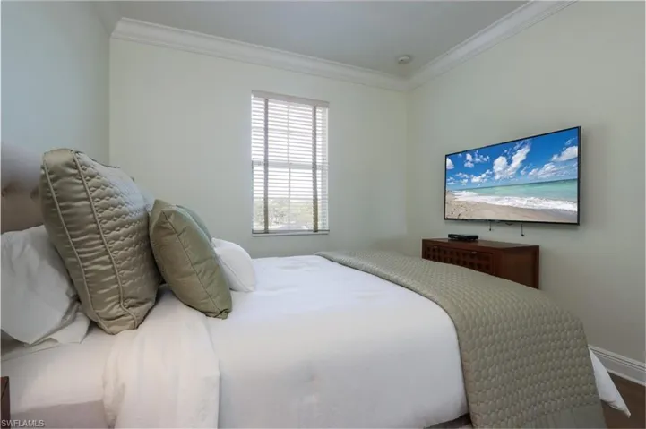 Bedroom featuring ornamental molding and wood finished floors