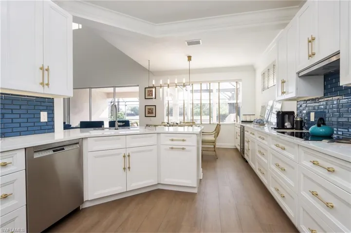 Kitchen with dishwasher, ventilation hood, a peninsula, light wood-style flooring, and white cabinets