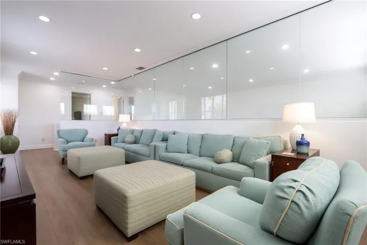 Living area featuring wood finished floors and recessed lighting